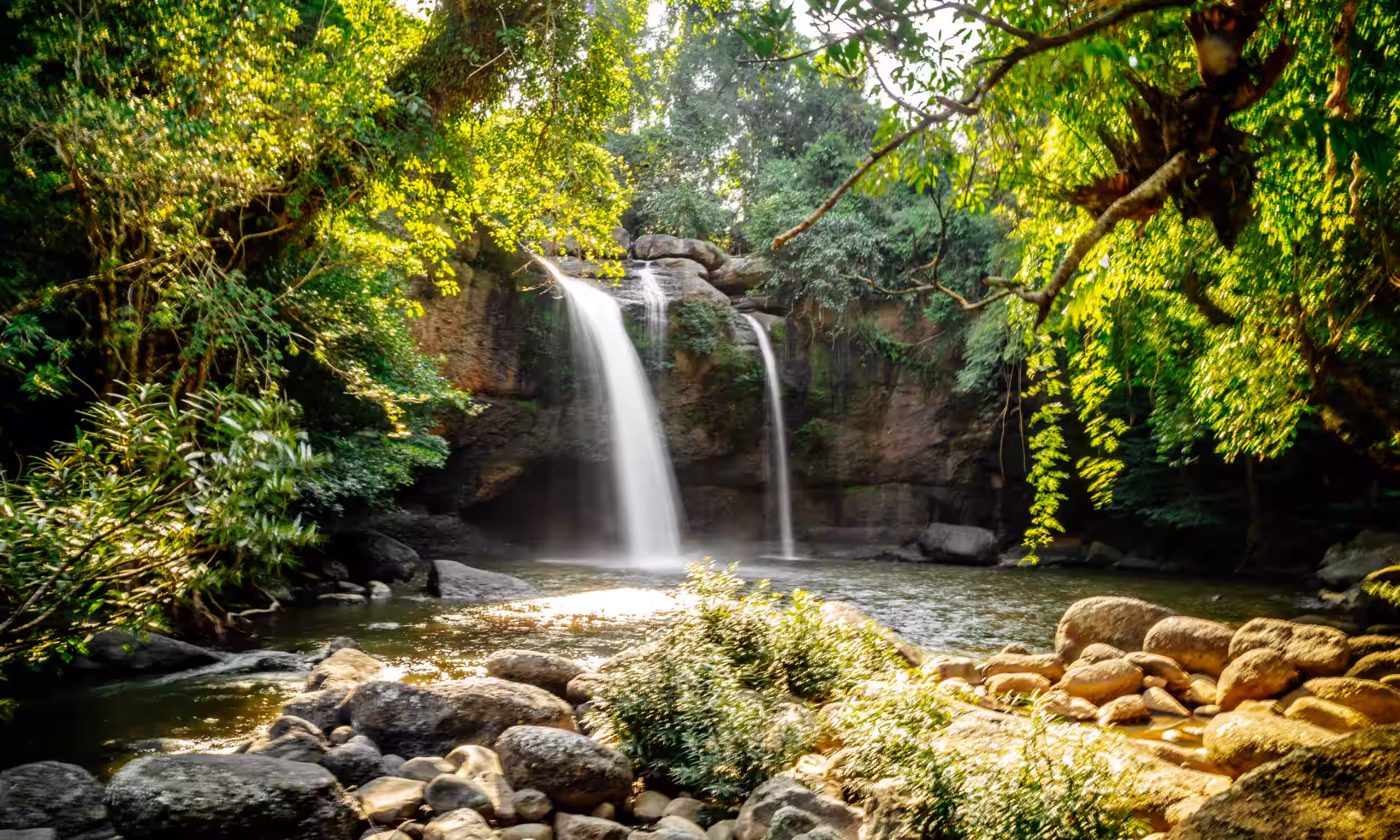 Haew Suwat Waterfall surrounded by tropical forest in Khao Yai National Park, Thailand.