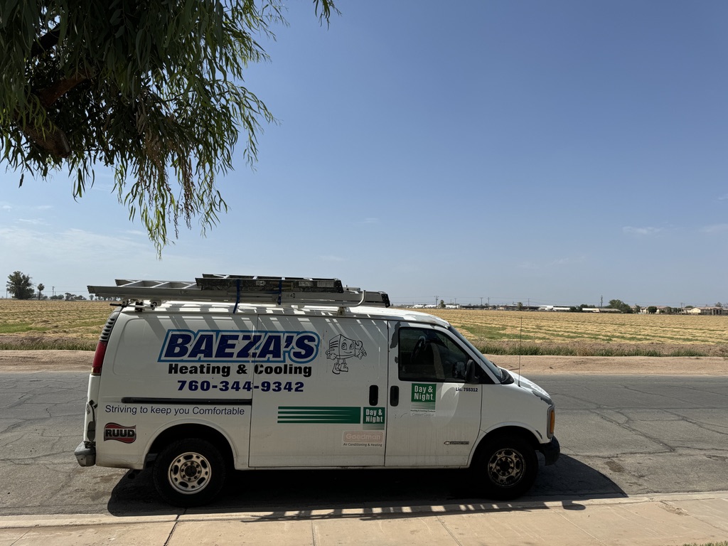 Baeza's Heating & Cooling service van parked on a road in El Centro, CA, featuring the company logo, contact number 760-344-9342, and a sign stating "Striving to keep you Comfortable."
