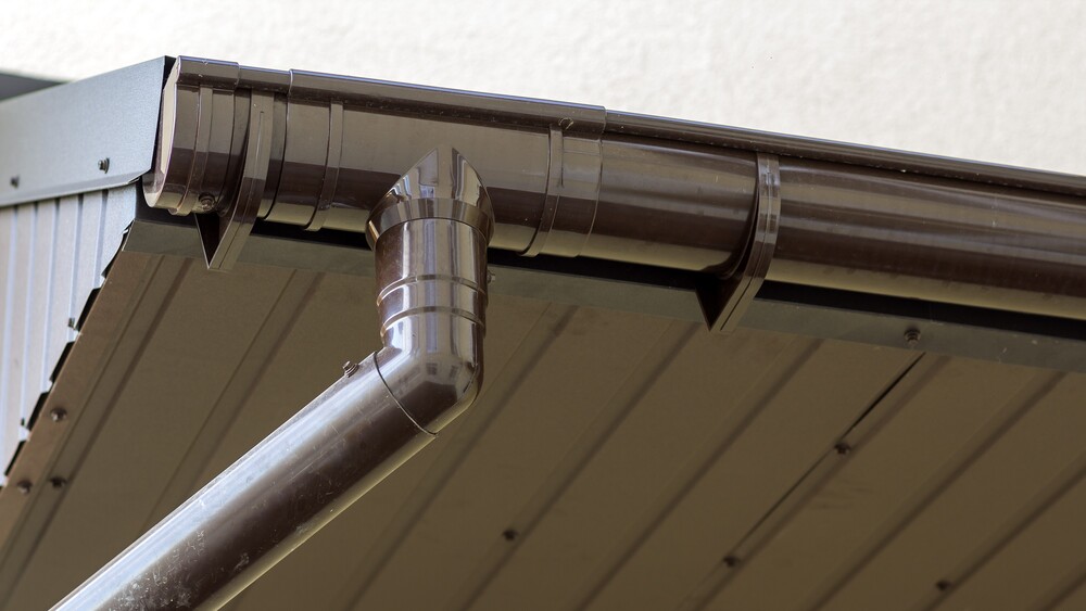 Close-up view of home with brown gutter system