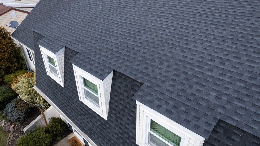 Close up  view of home with dark asphalt shingled roof