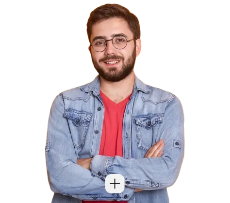 A man wearing glasses and a denim jacket.