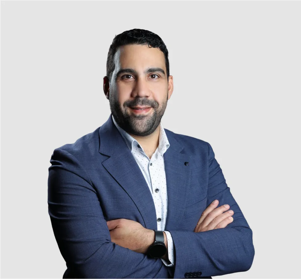 A man in a blue suit with his arms crossed.