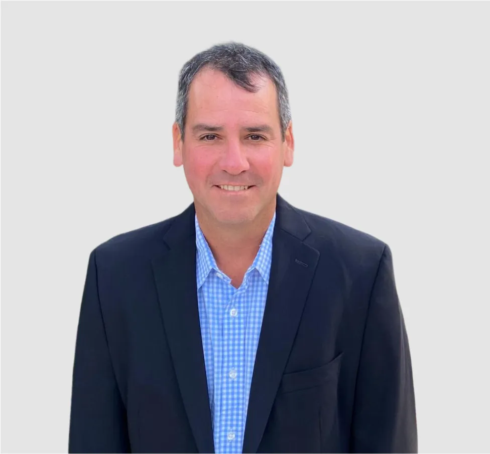 A man in a blue shirt and black jacket.