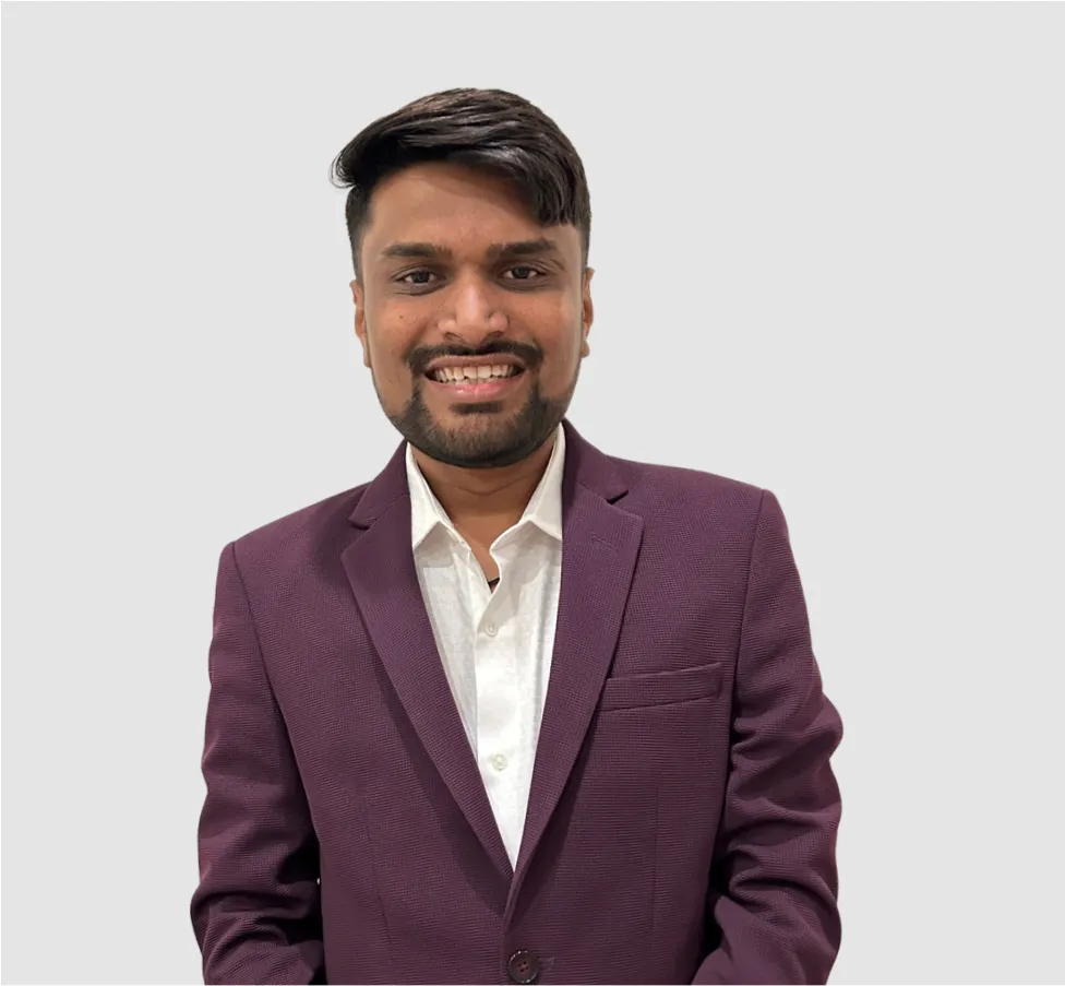 A man wearing a purple suit and white shirt.