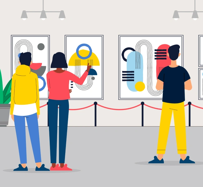 A group of people looking at art on display.