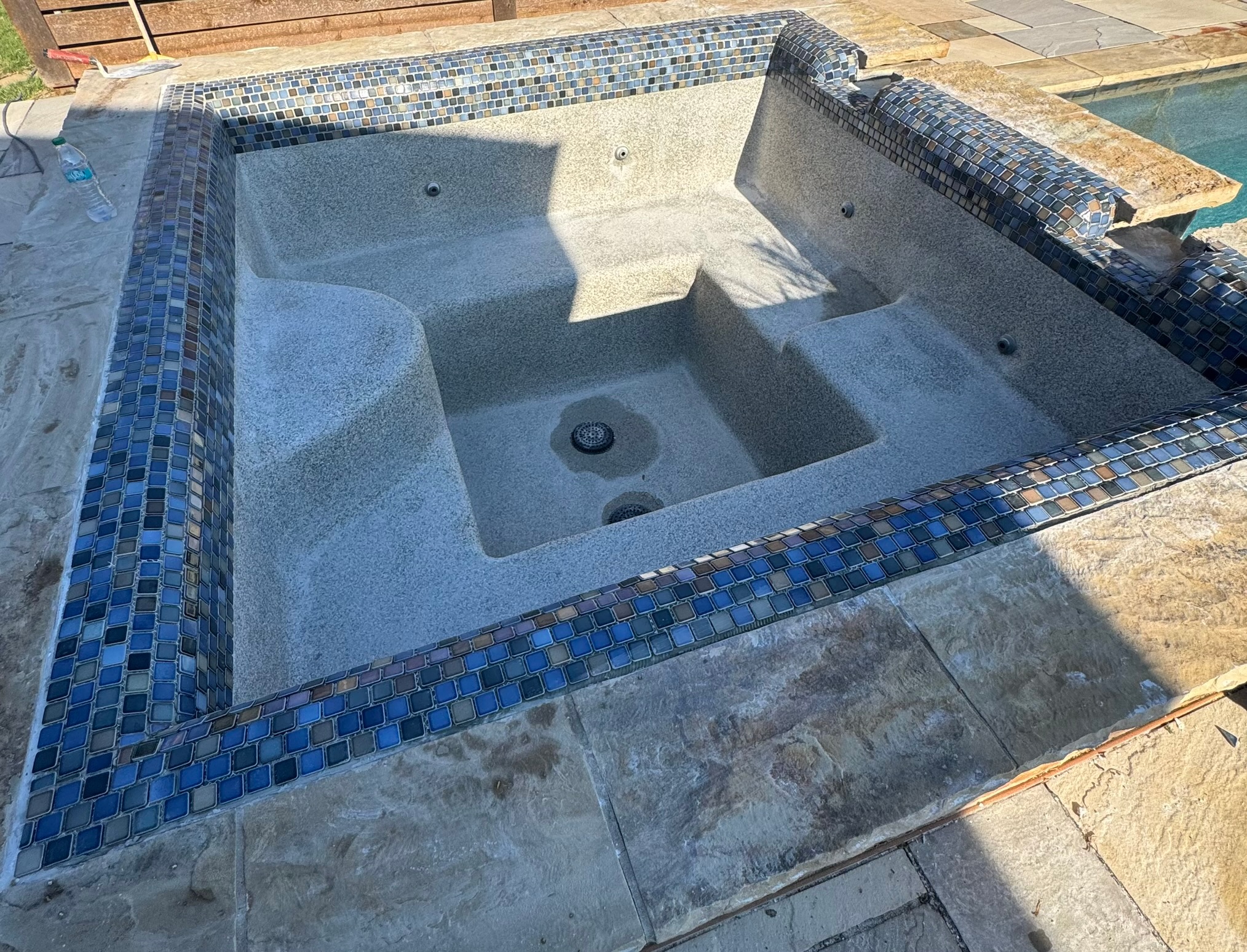 Remodeled spa with new blended glass tile