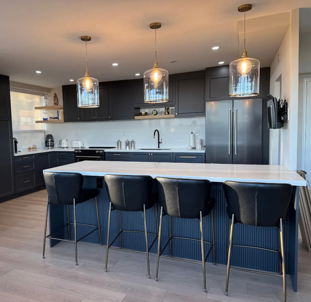 Custom navy IKEA kitchen with island and pendant lights