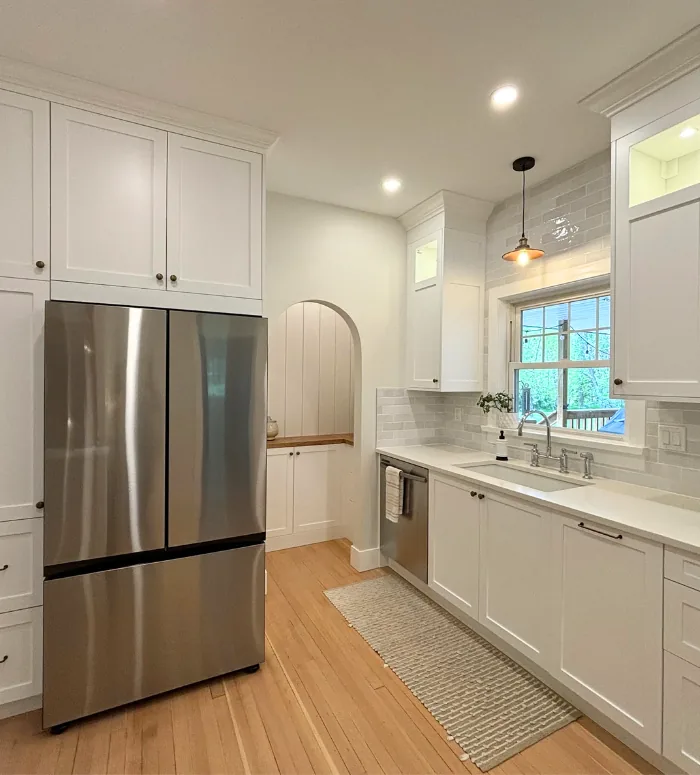 Built-in fridge wall with white custom doors