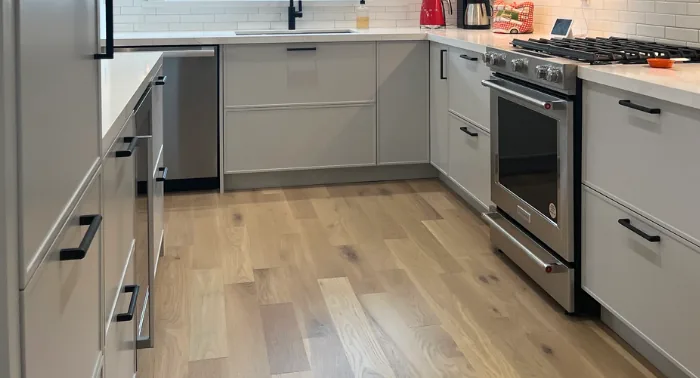 Grey custom kitchen cabinets with wood floors