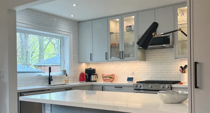 Grey custom IKEA kitchen with stainless range hood