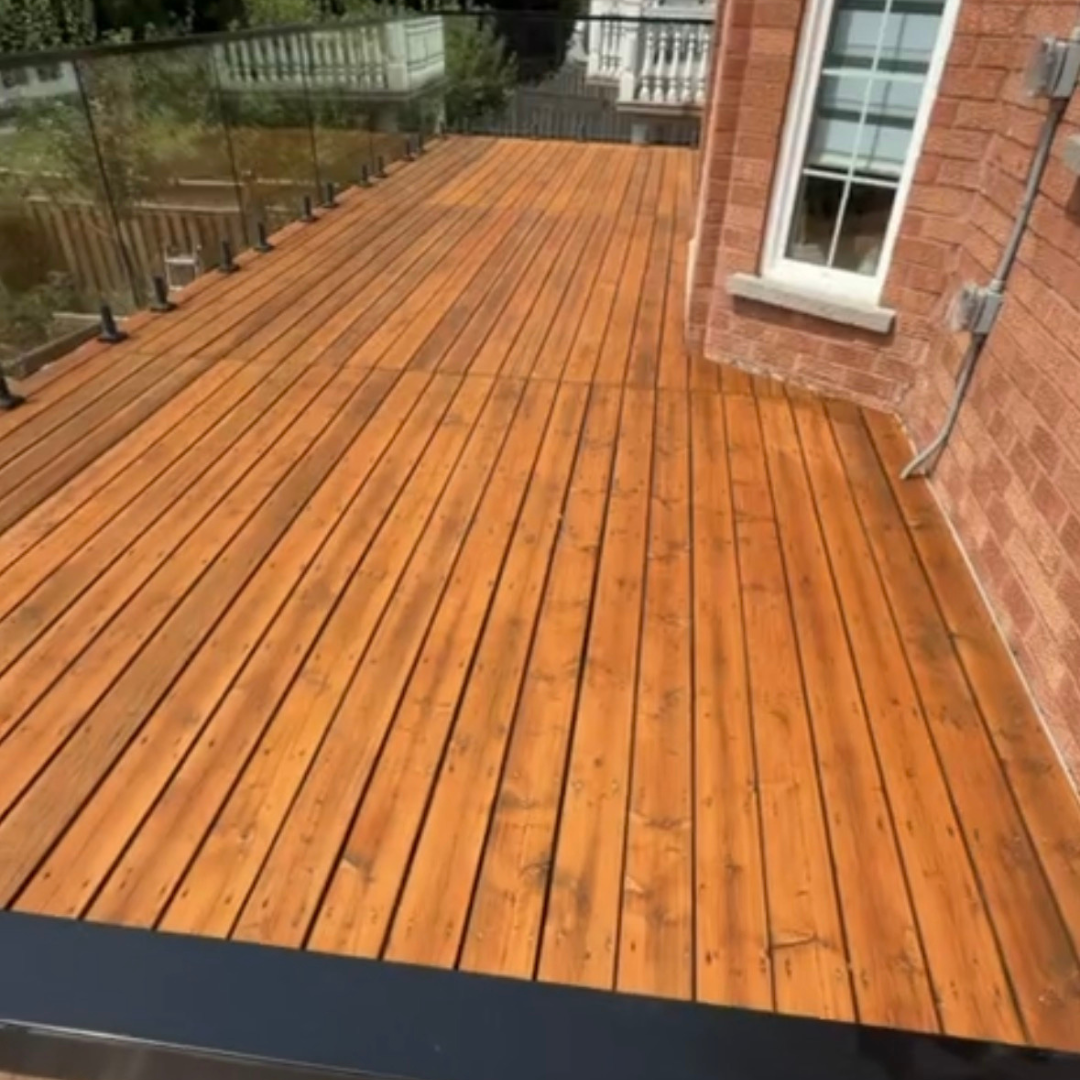deck with glass railings; stained with semi-transparent stain.