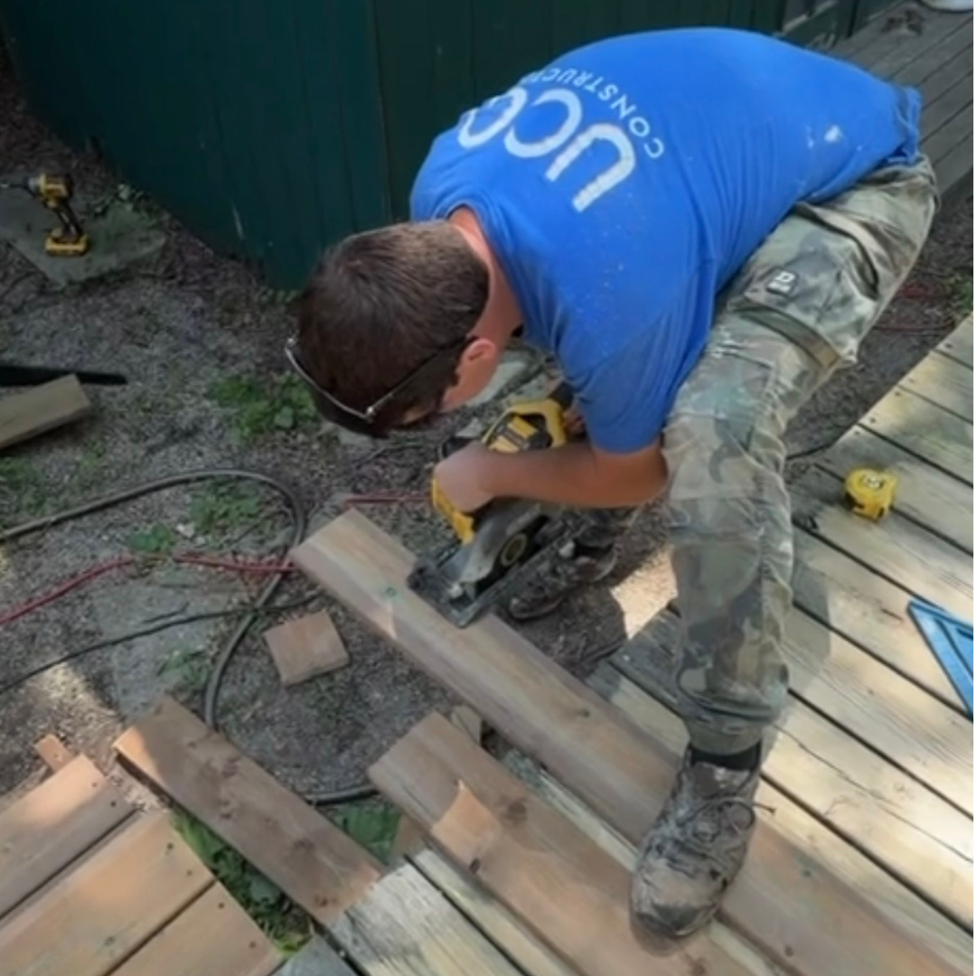 UCO Construction group worker cutting a deck board