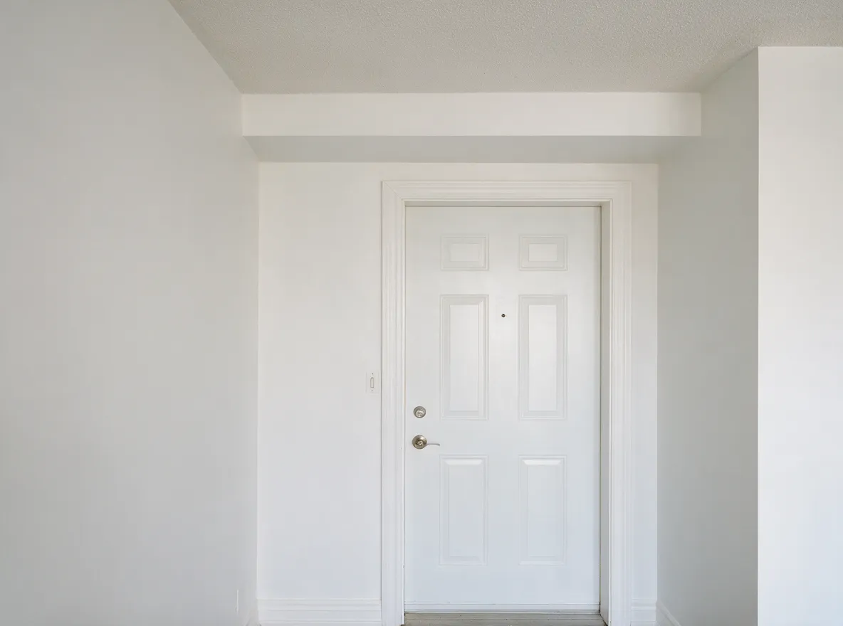 Condo entryway with freshly painted white walls, door and trim, interior painting Toronto