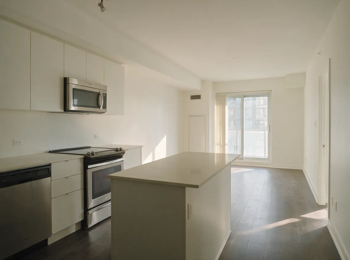 Open-plan condo kitchen and living room repainted warm white, UCO interior painters Toronto