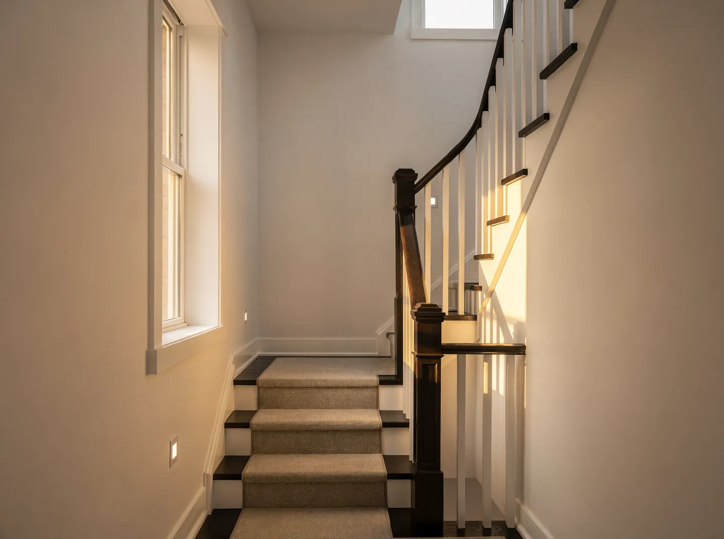 Repainted hallway and staircase with white walls and spindles, Toronto house painters
