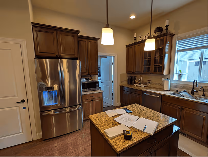 Original Bonney Lake kitchen with dark espresso cabinets, gold granite countertops, and peninsula blocking the living room view