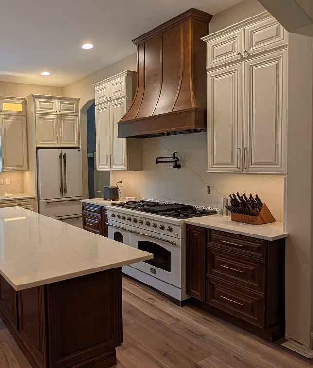 Remodeled kitchen featuring a white gas range, custom dark wood range hood, dark wood lower cabinets, and off-white upper cabinets.