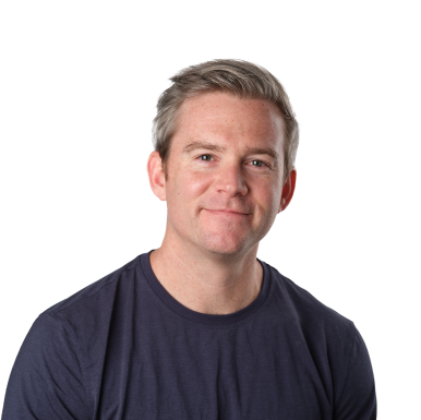 Dave Wardell, a white man with a soft smile and slightly graying hair, wearing a navy t-shirt