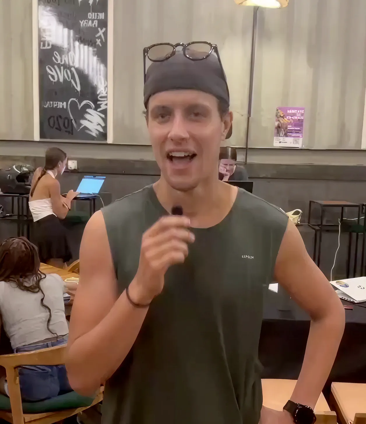 A man with a funny hat holding a microphone.