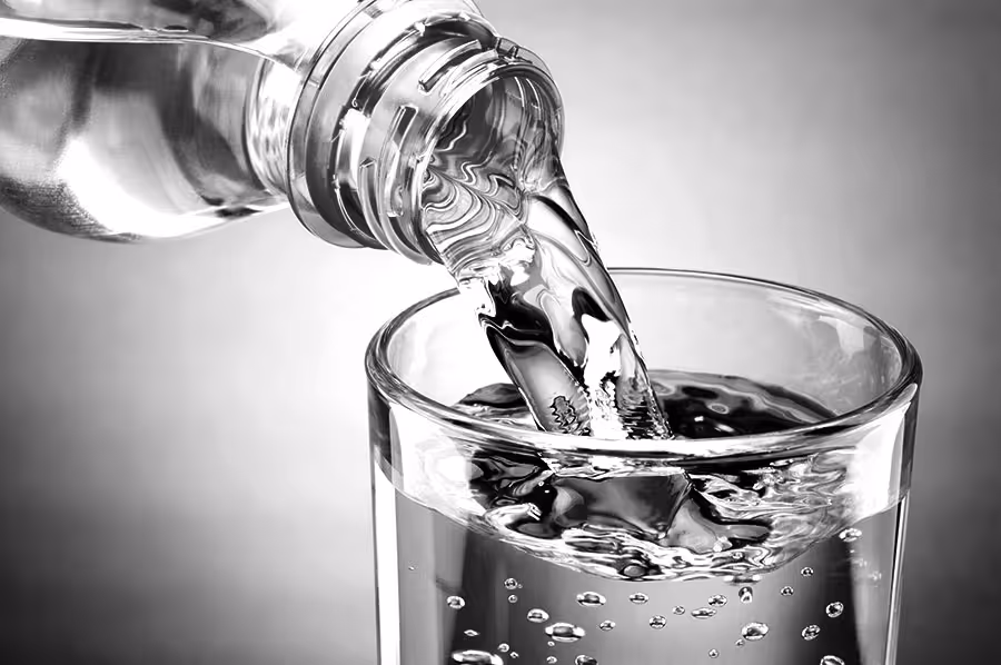 Platinum Wells Spring Water pouring into glass