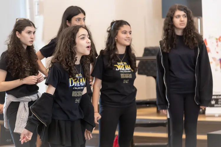 The full cast of Dare to Dream celebrates together following a successful musical theatre performance in North Vancouver
