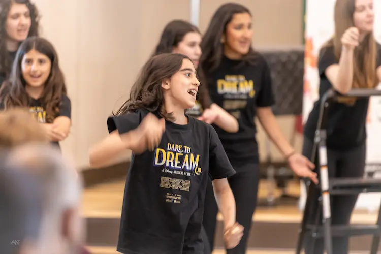 Young performers bring characters to life during a scene from Dare to Dream at Cadenza Music & Art Academy