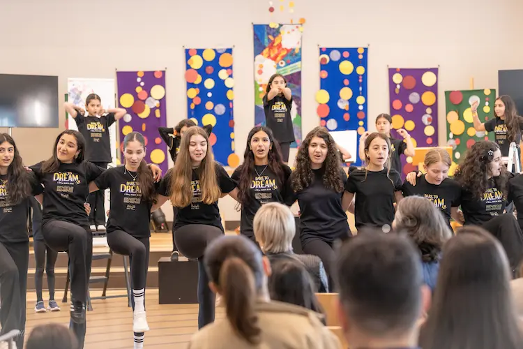 Student actors showcasing confidence and creativity on stage during the Dare to Dream musical