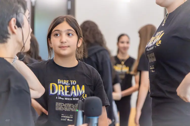 Dynamic stage performance featuring young actors and singers in the Dare to Dream showcase