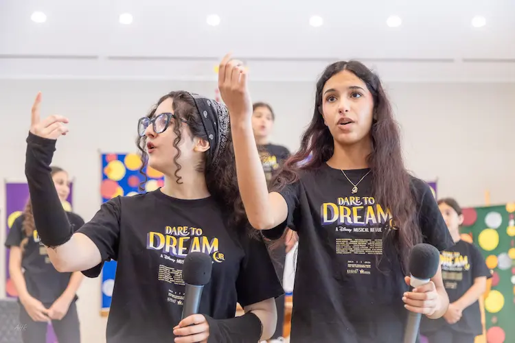 Cast members engaging audiences with a memorable scene from Dare to Dream in North Vancouver