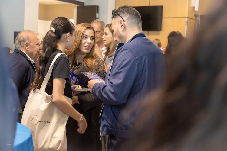 Excited audience members celebrating young performers during a live musical theatre event