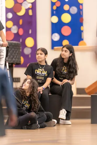 Cast members performing an emotional musical theatre scene during the Dare to Dream production in North Vancouver