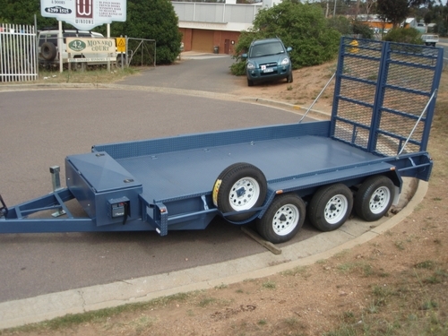 Large, blue car trailer, triple axle.