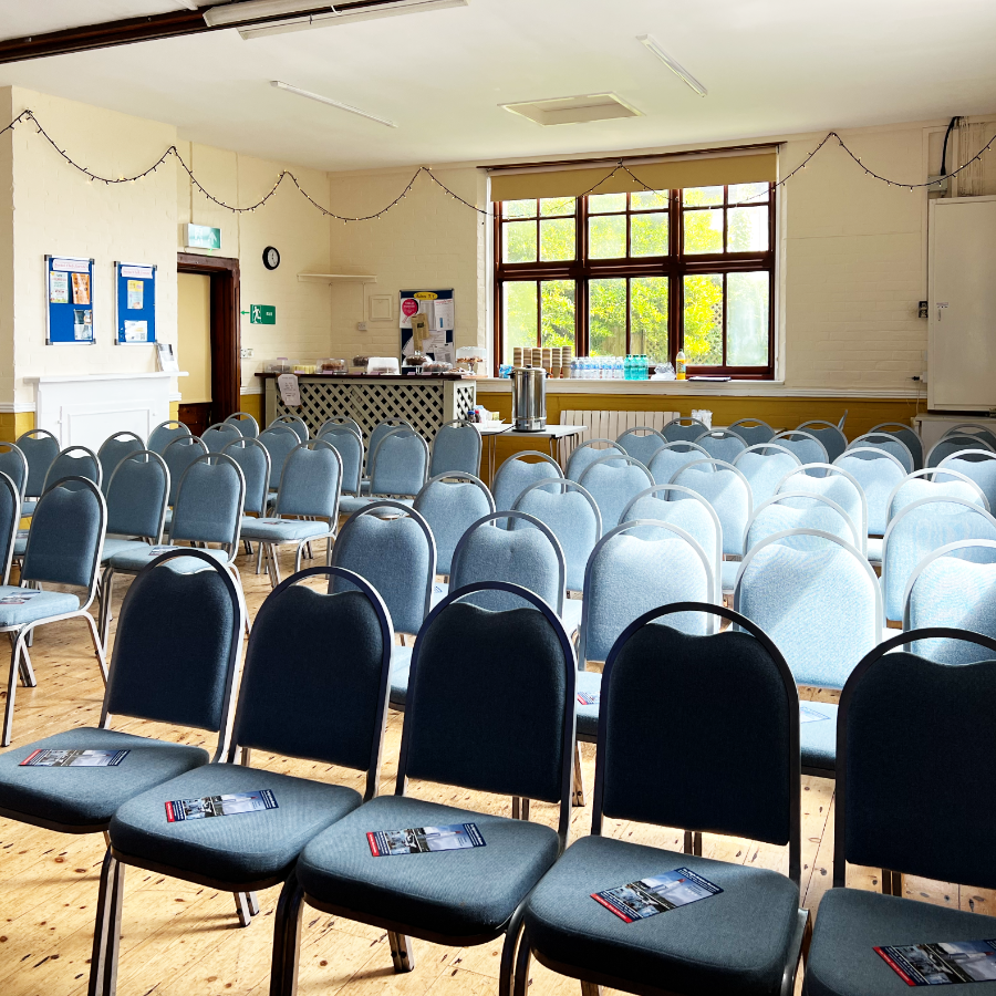 A village hall set up with chairs ready for a talk