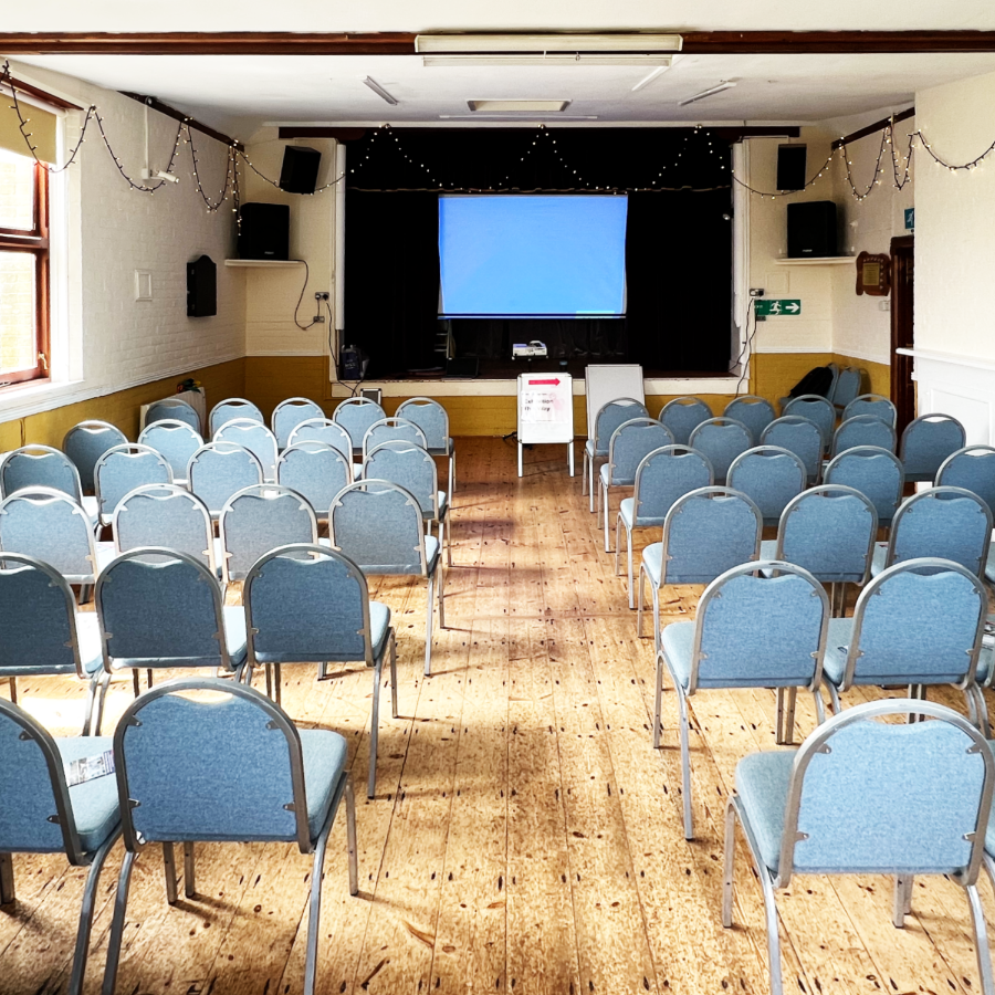 A village hall set up with chairs ready for a talk