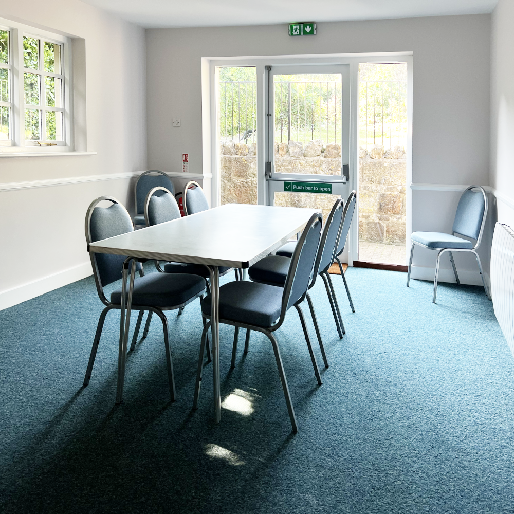 A small meeting room with tables and chairs