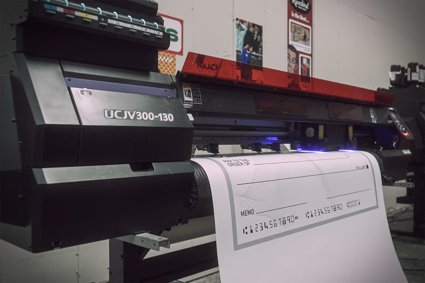 A Mimaki UCJV-300-160 printing on a white material.