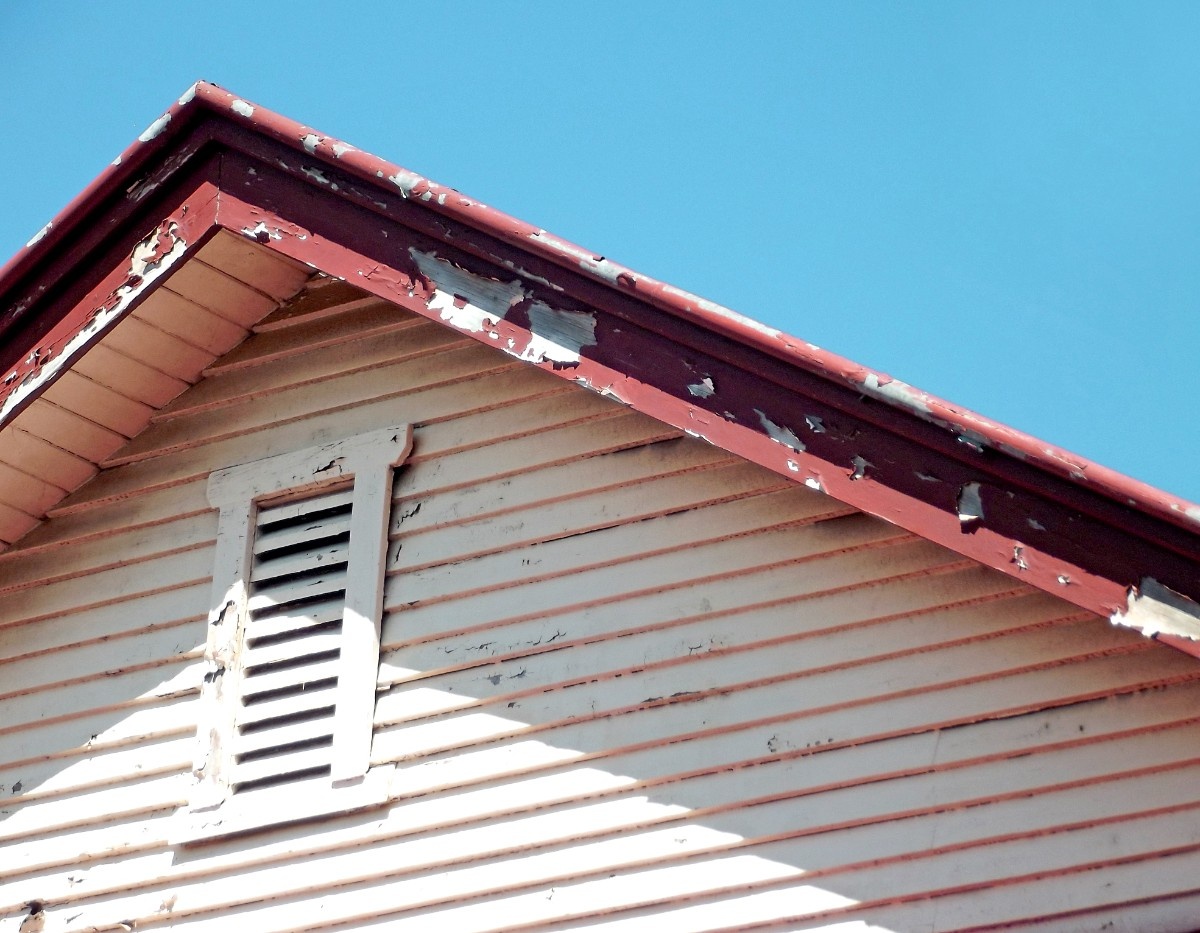 Early signs of rot on a wooden siding and roof of a Bellevue home
