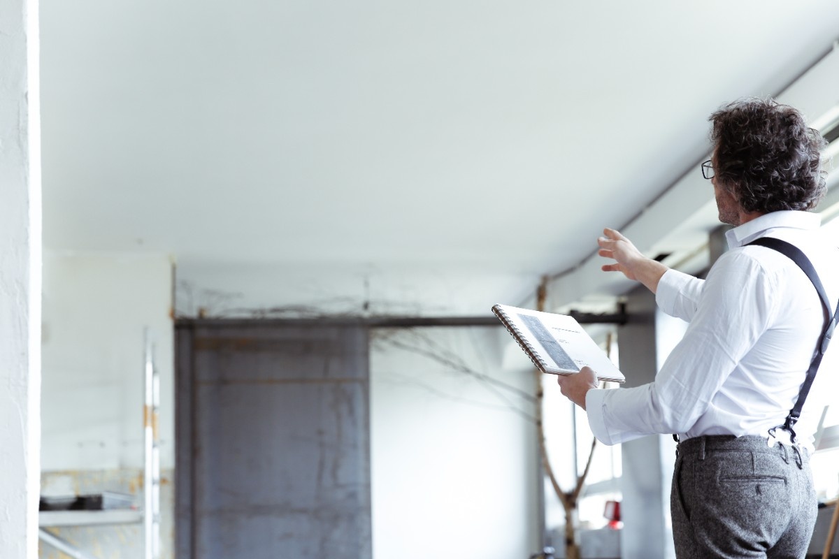 A contractor guiding a homeowner during house inspection for dry rot in Bellevue
