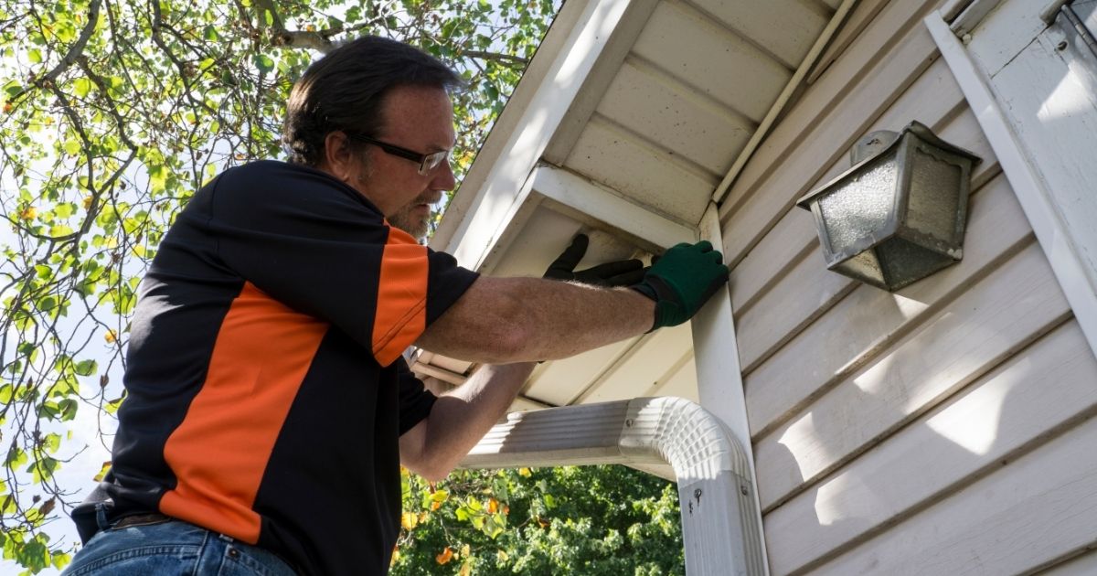 Contractor fixing vinyl siding