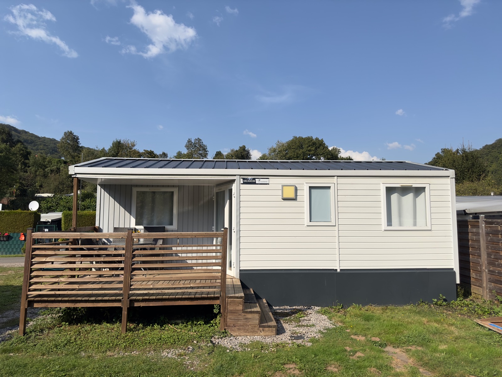 Mobilheim 5 von außen mit überdachter Holzterrasse