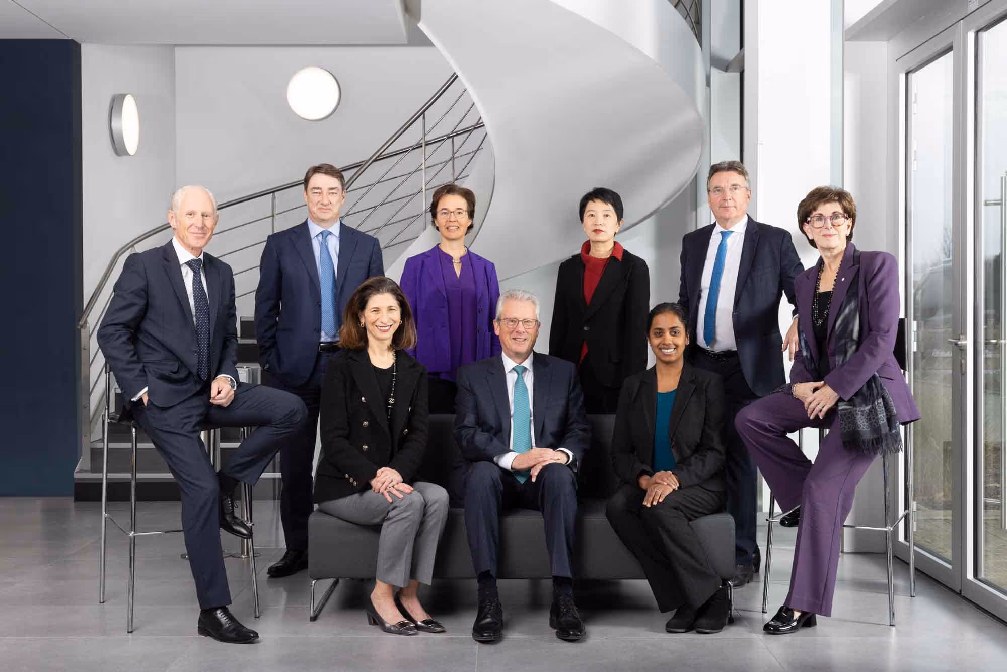 A group of business people pose for a photo.