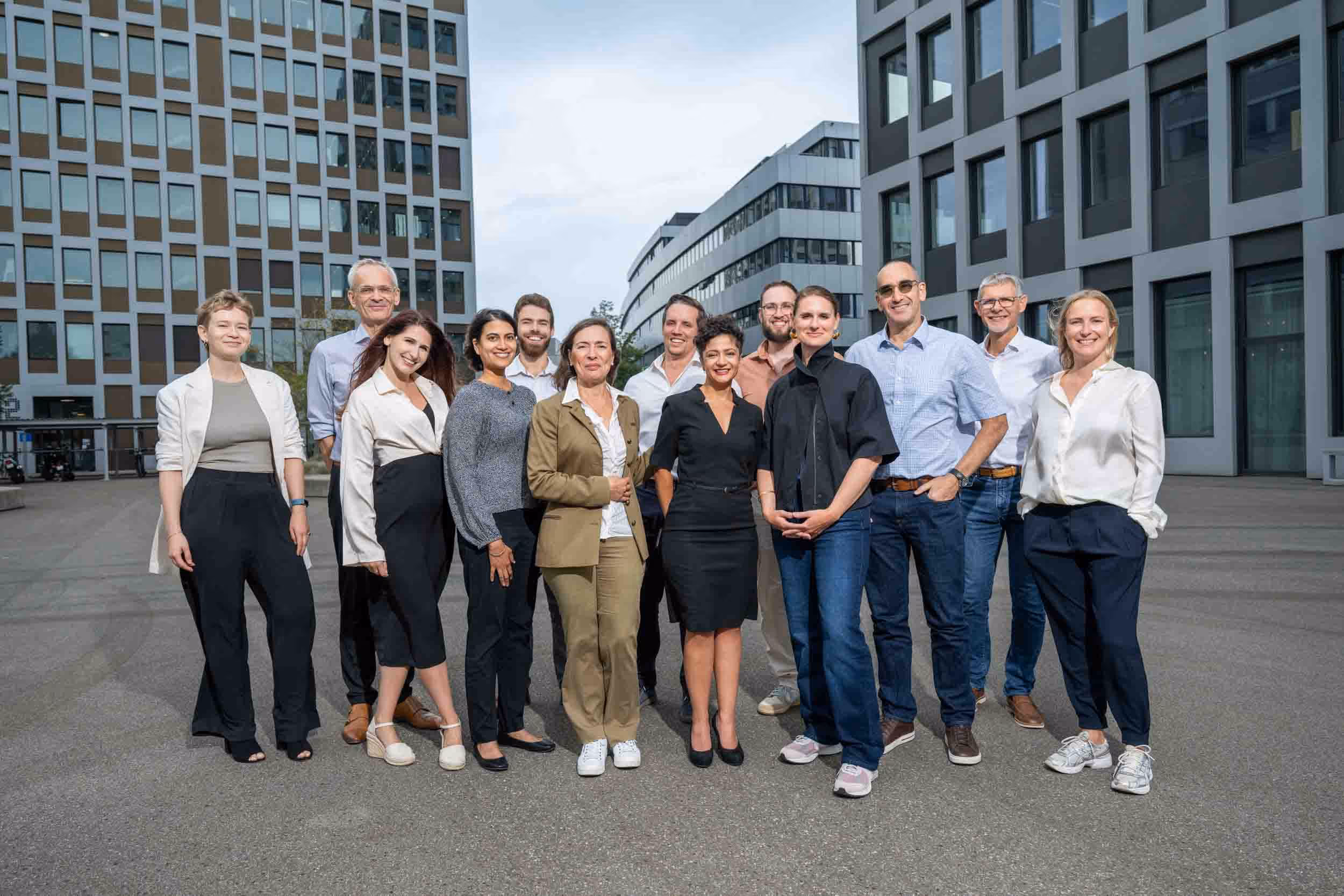 A group of people stand in front of a building for a group photo.