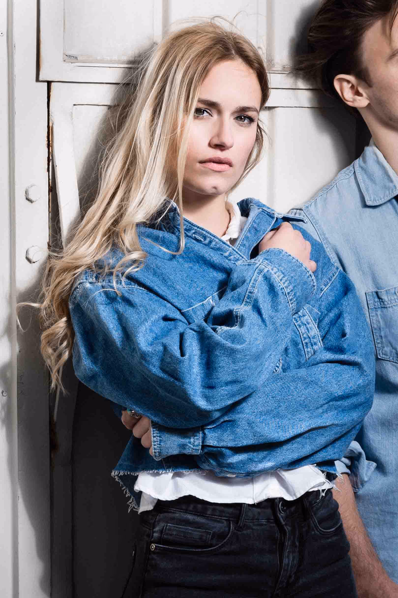 A woman in a blue jacket and jeans.