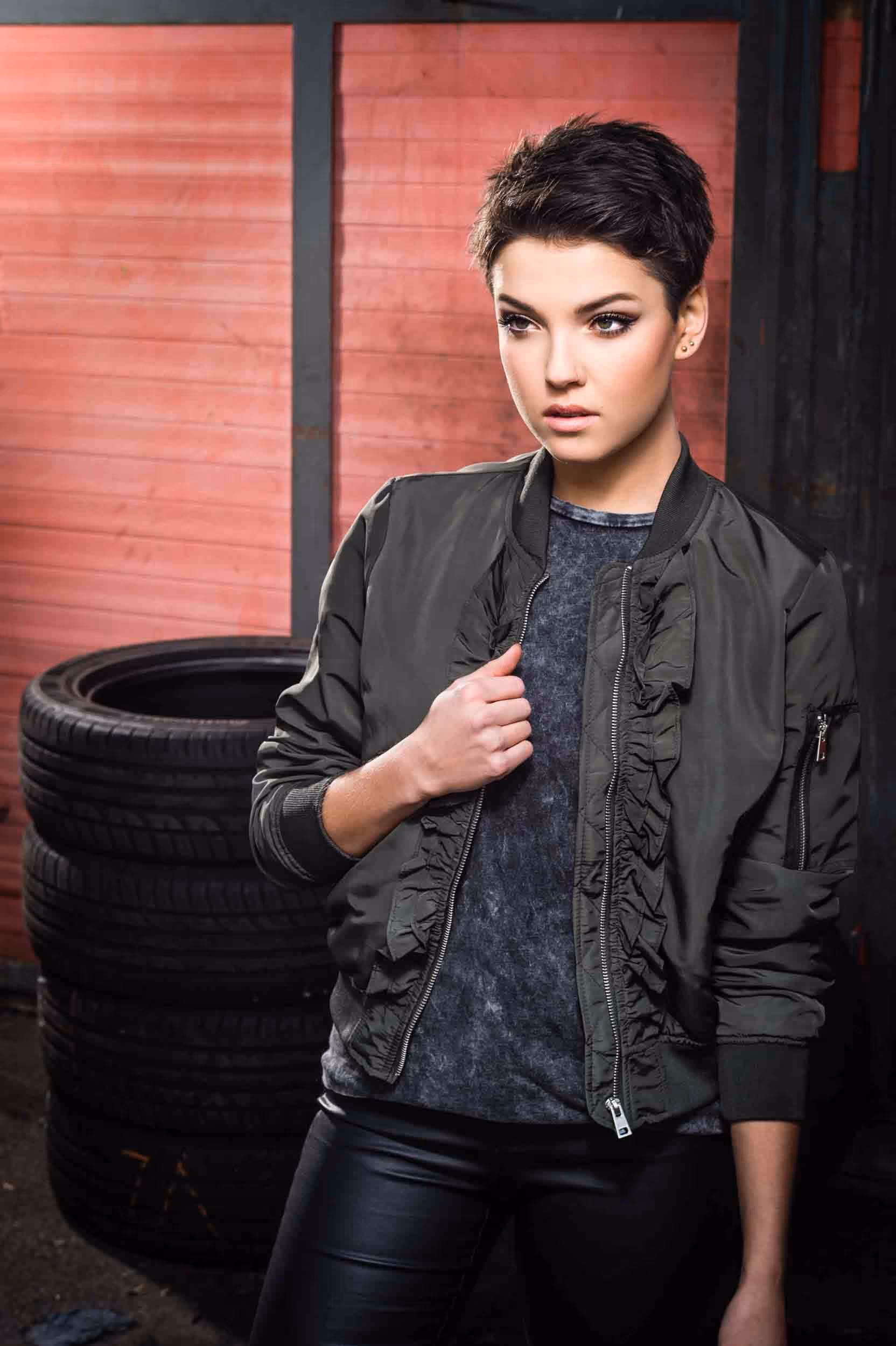 A woman in a black leather jacket and black trousers.