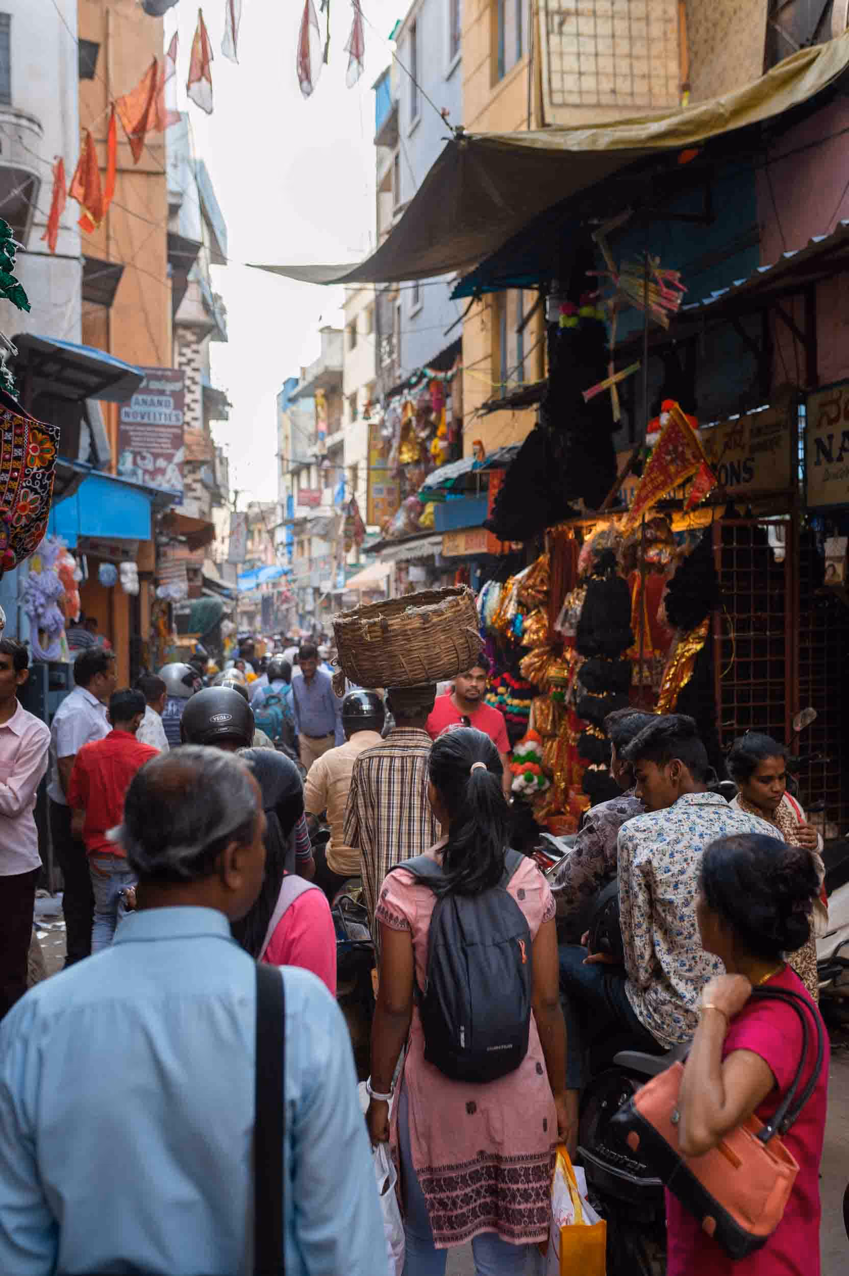 A group of people walking along a busy street in Bengaluru.