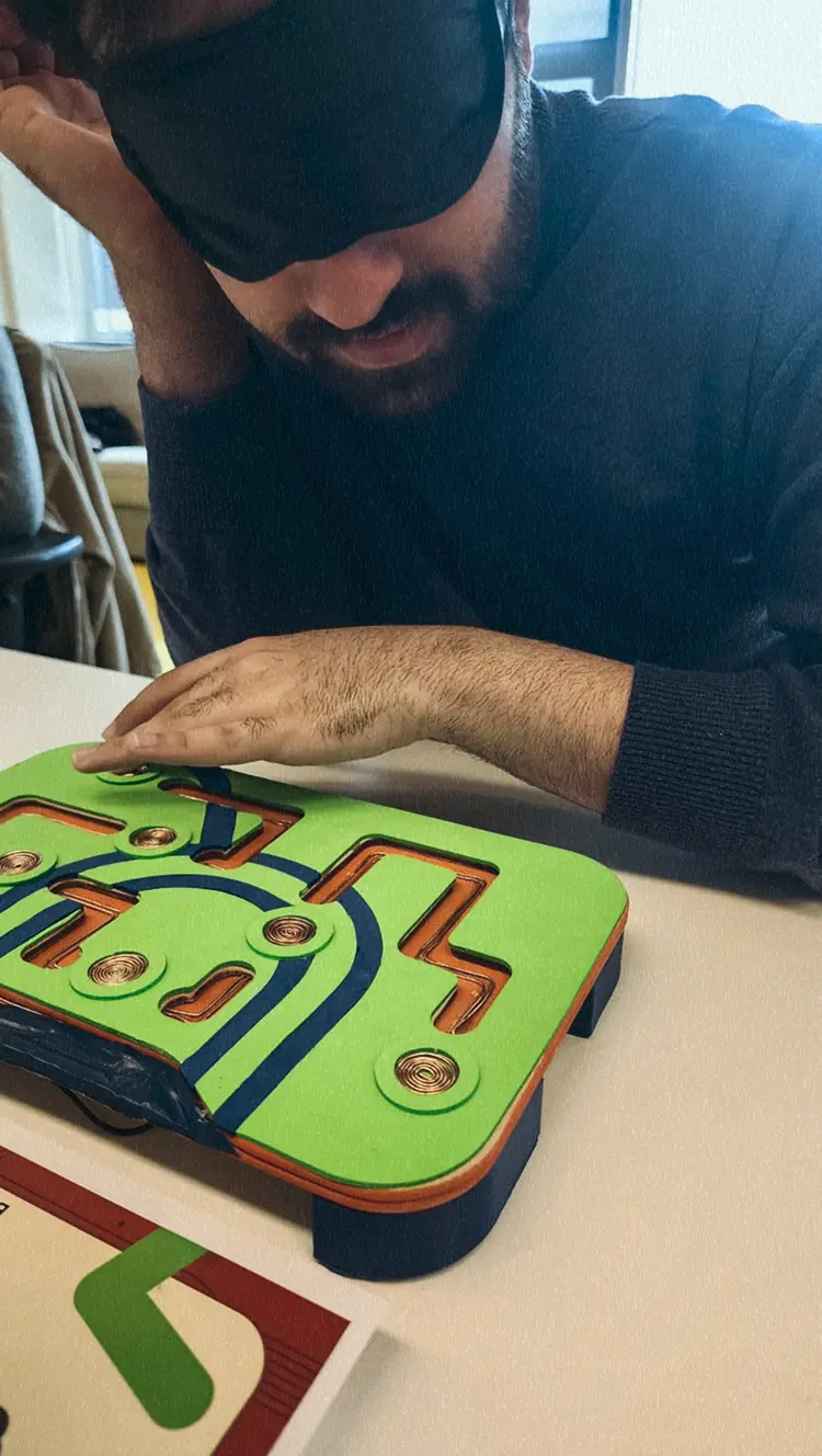 Man with a blindfold using the Metro Mates toy