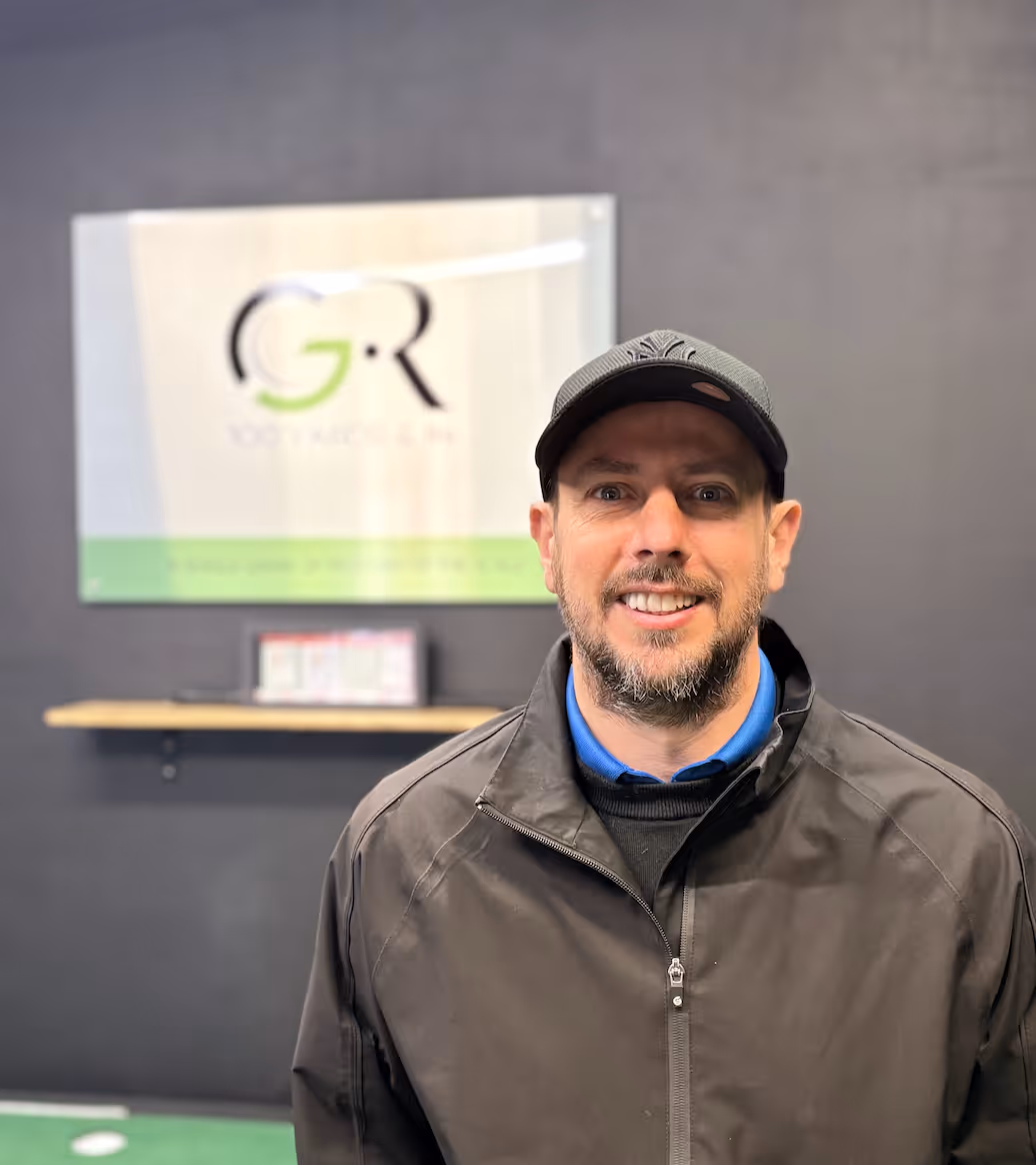 Luke Murray posing for the camera in front of the Graham Roberts Golf logo