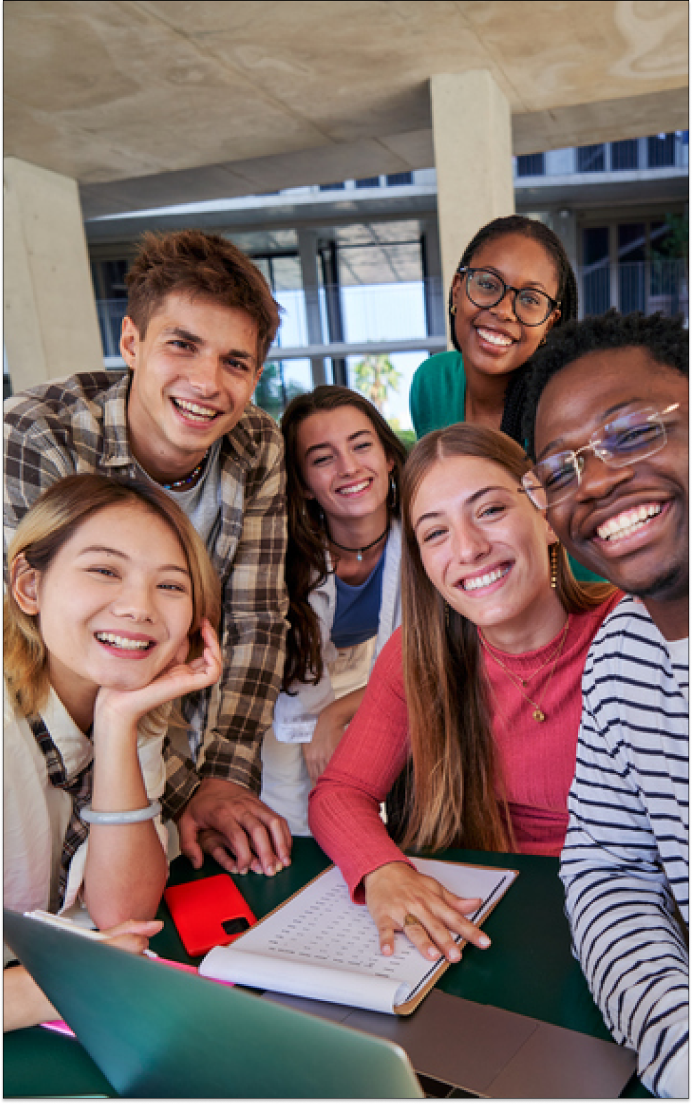 Students in a classroom discussion, engaged and smiling