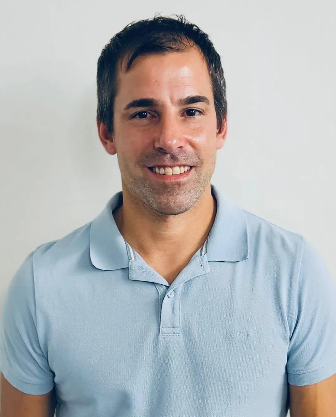 Young Man with a blue Polo-Shirt and a bright Smile
