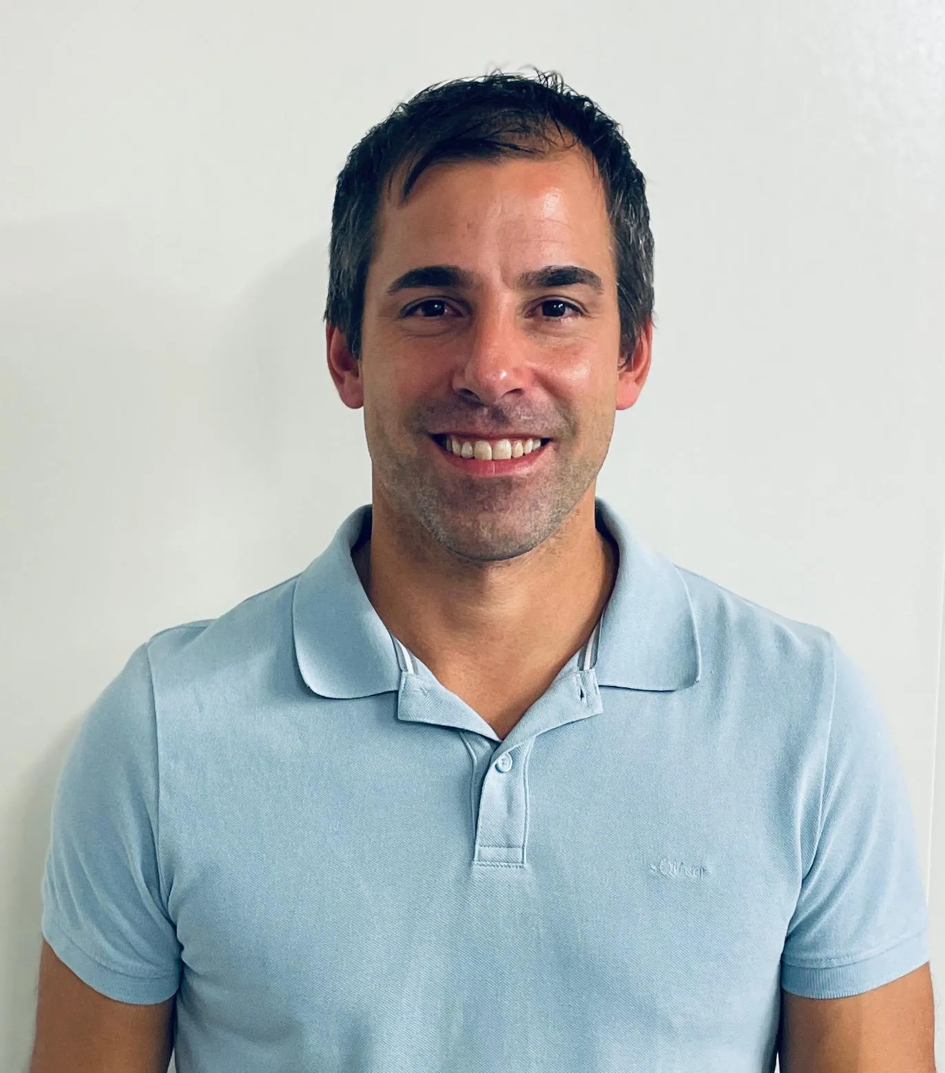 Young Man with a blue Polo-Shirt and a bright Smile
